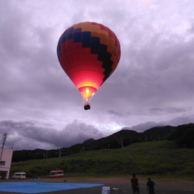 Tethered hot air balloon ride at sunset.